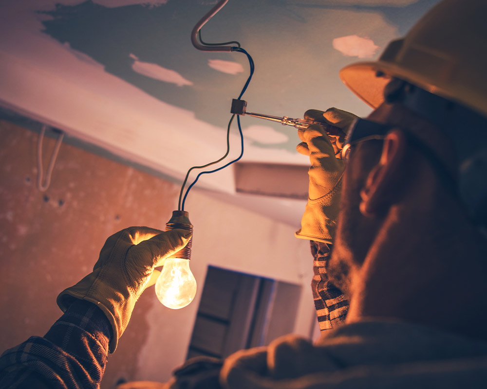 electrician repairing light bulb kyle tx